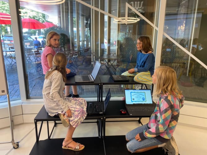 GirlsCodeToo participants coding together during a workshop.